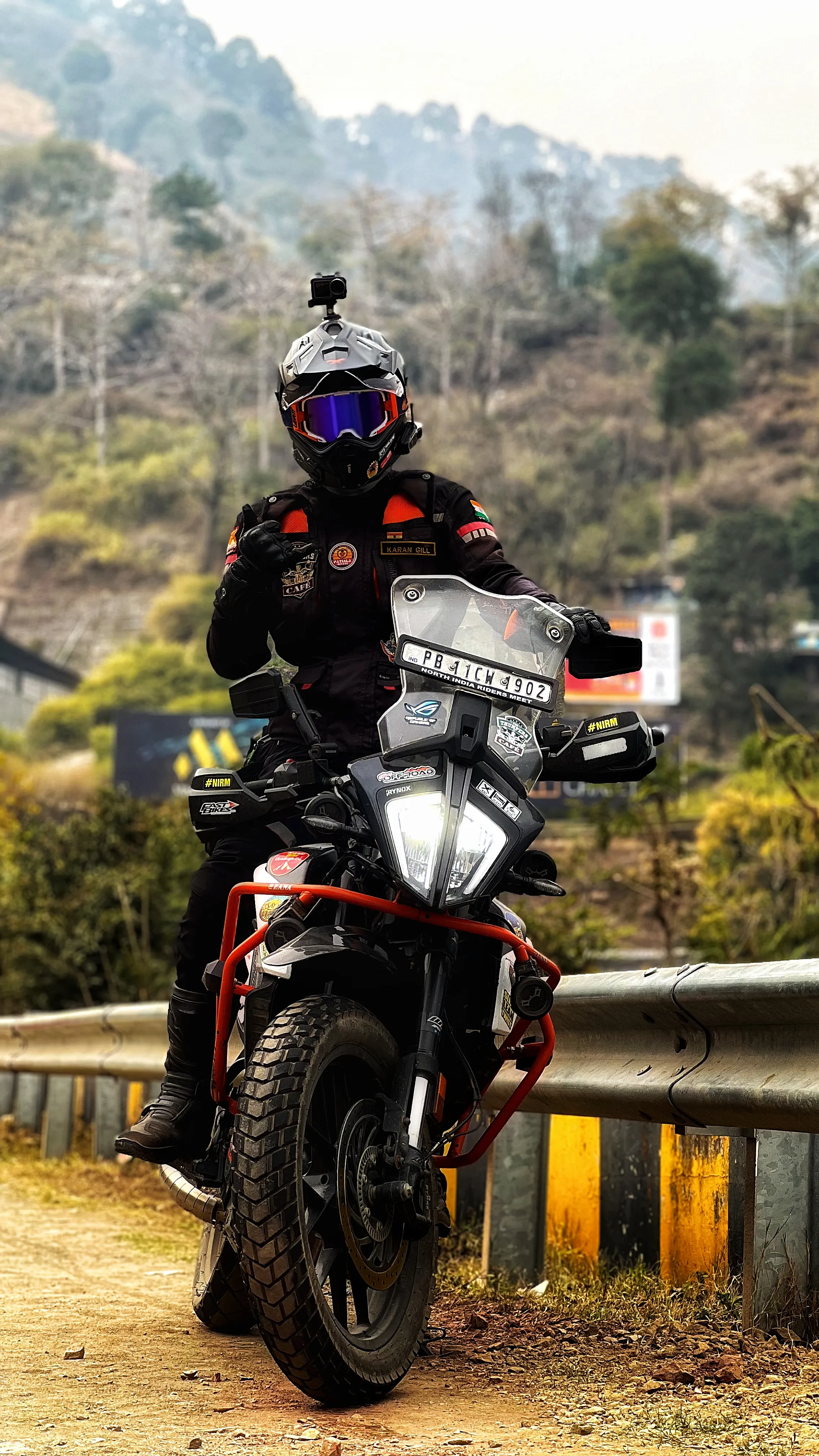 Karan Gill on his KTM 390 Adventure motorcycle in a remote mountain range